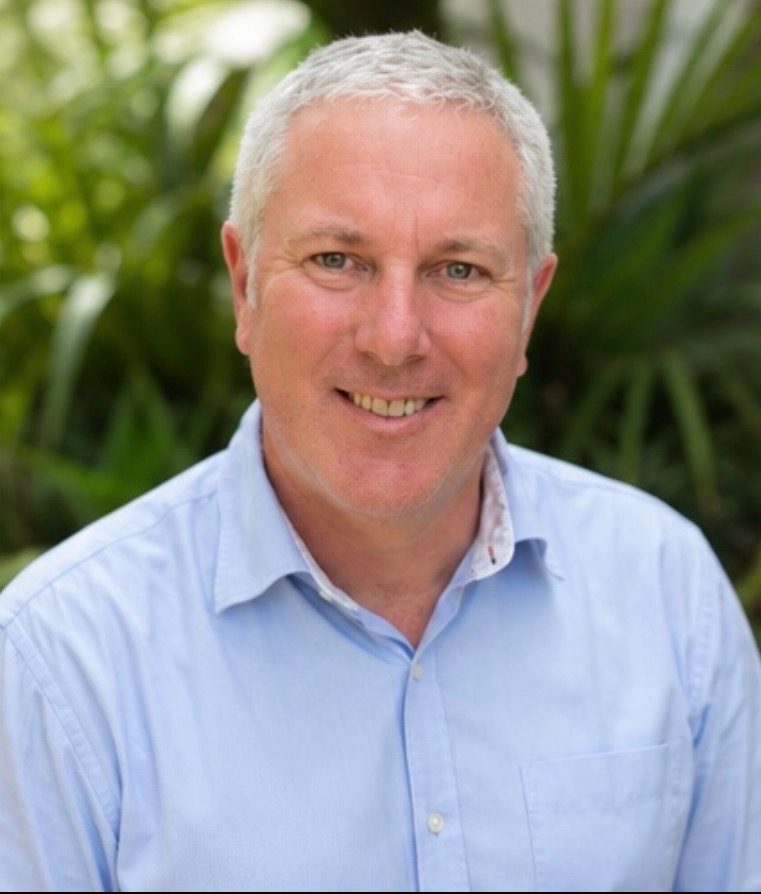 Portrait of Dr James Harris outdoors with greenery in the background, used as the Harris Chiropractic website footer image.